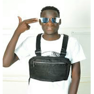 Evy Treyz, Ugandan artist from Karamoja, standing outdoors in a stylish modern outfit