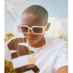 Black Weapon posing for a promotional photo in stylish attire, representing Teso music culture.